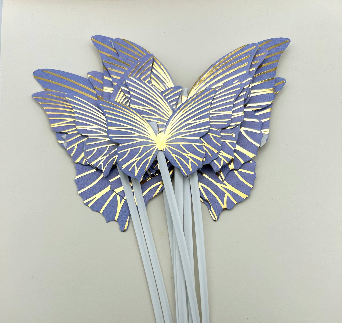 Purple and gold butterflies with stick
