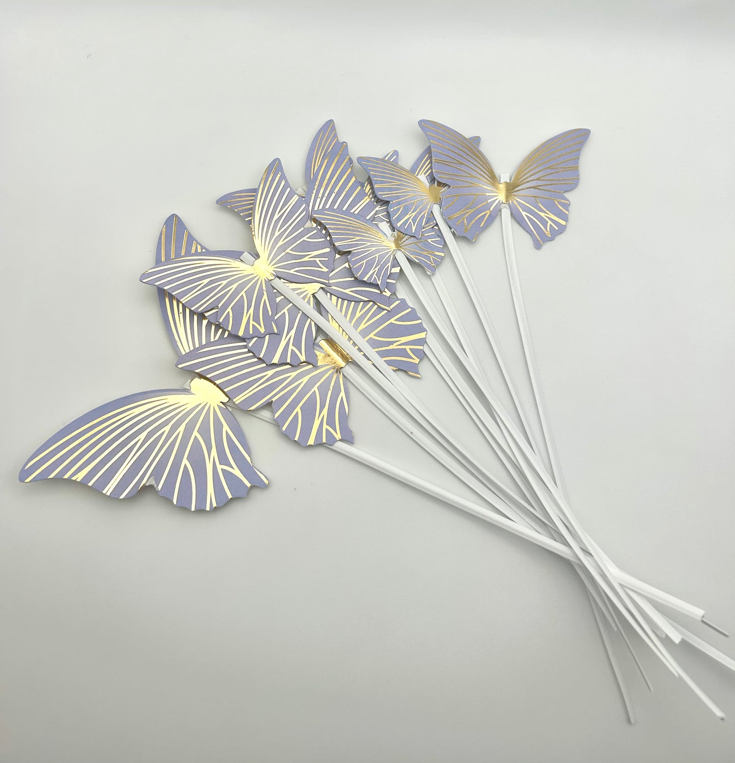 Purple and gold butterflies with stick