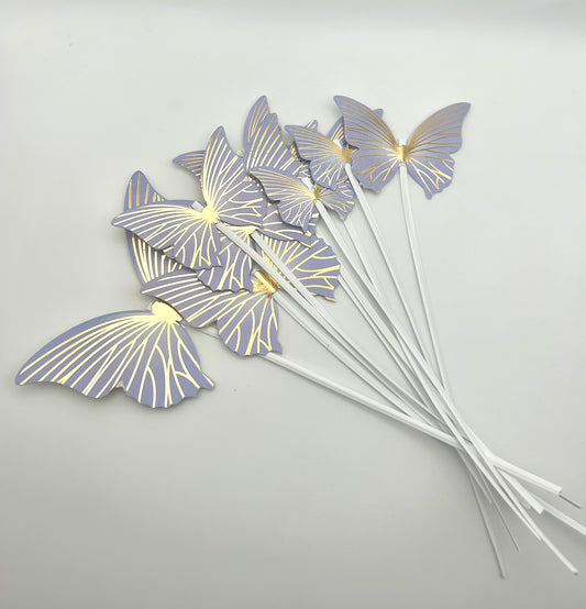 Purple and gold butterflies with stick